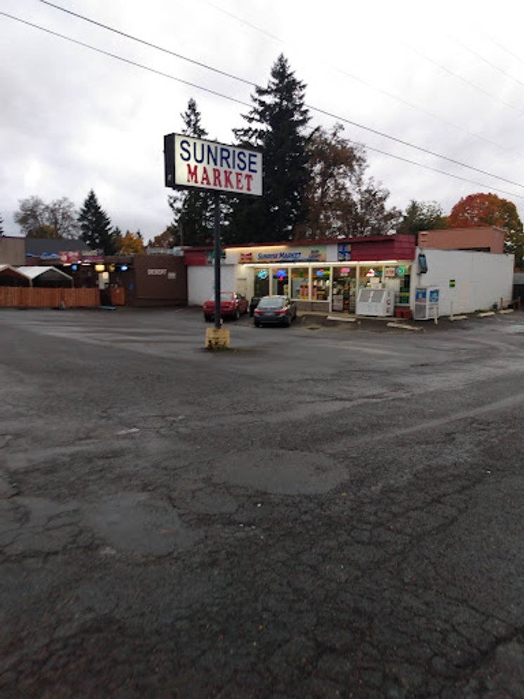 Sunrise Market parking lot and roadside sign
